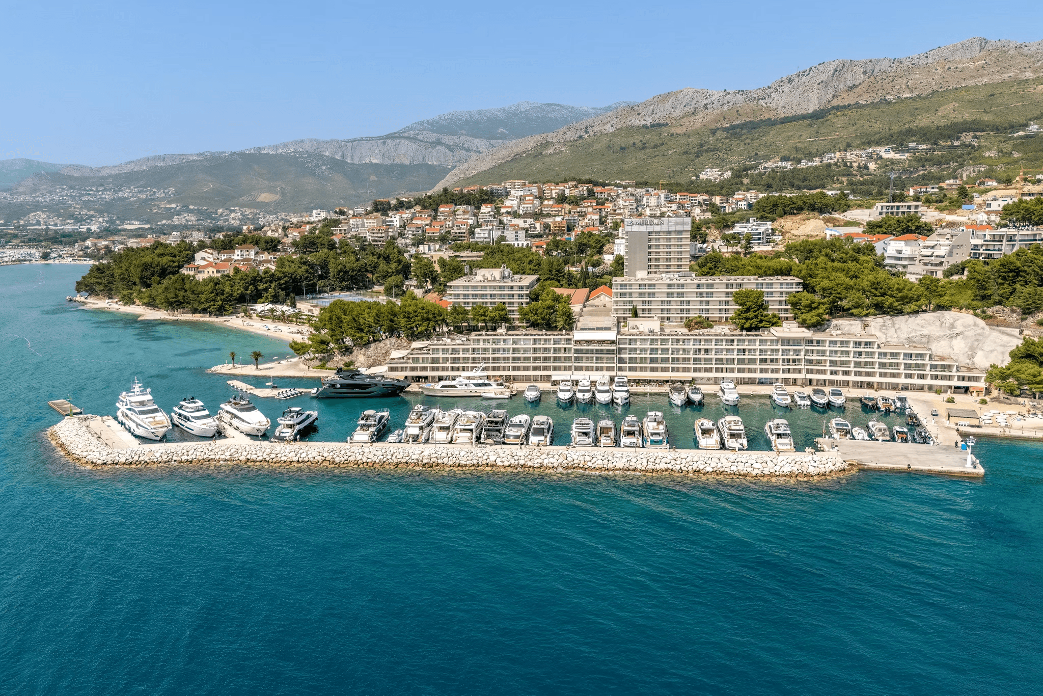 Le Méridien hotel on the Adriatic coast with marina and turquoise water